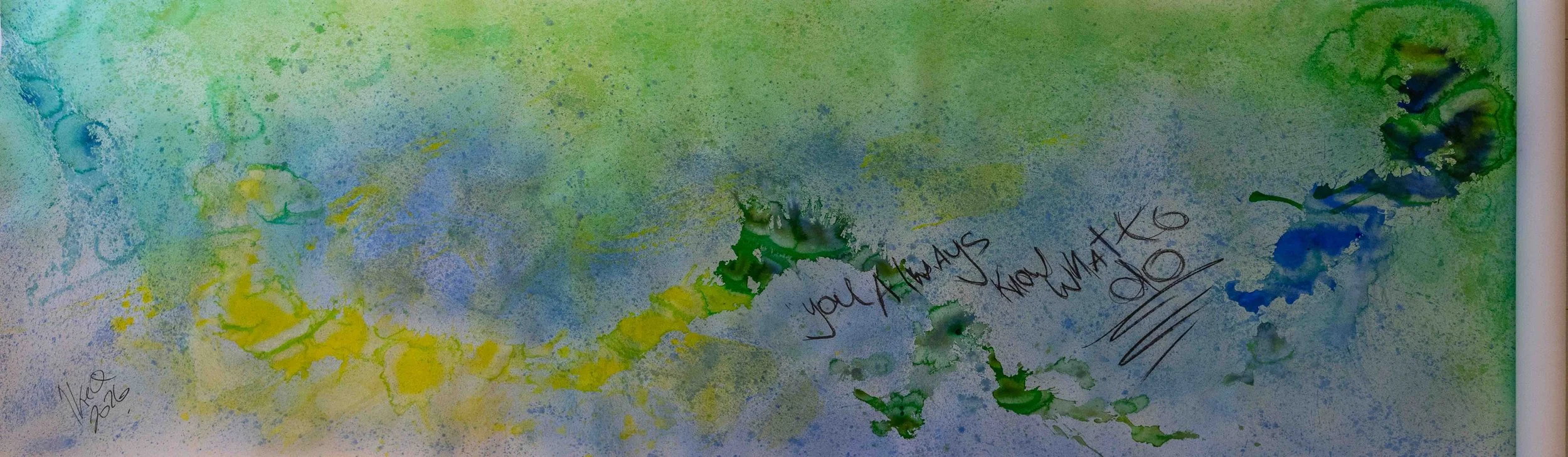 Colorful abstract painting with splashes of pink, purple, orange, yellow, green, blue, and white paint, covering a large rectangular canvas.