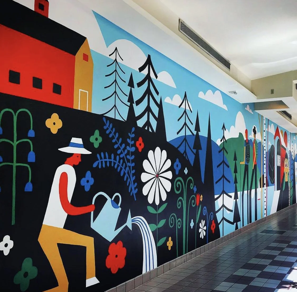 Colorful mural depicting outdoor scenes with trees, a person watering plants, flowers, and distant buildings under a blue sky with white clouds.