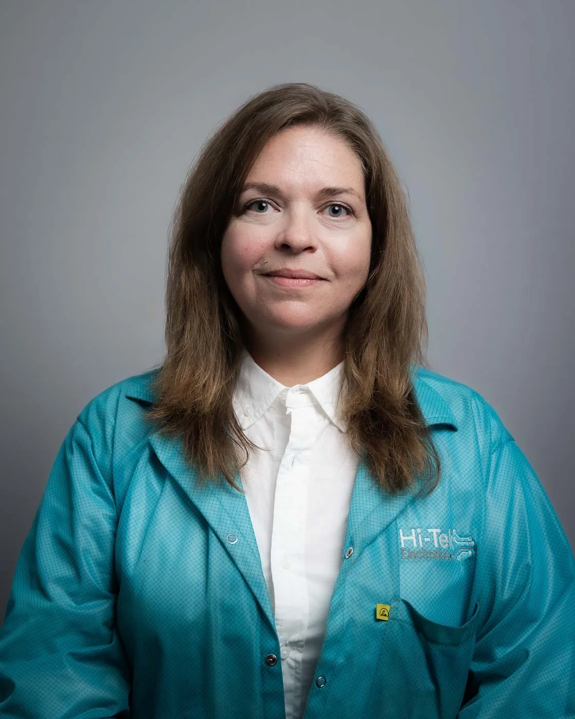 Headshot of an in uniform Hi-Tek Electronics employee, with a grey background