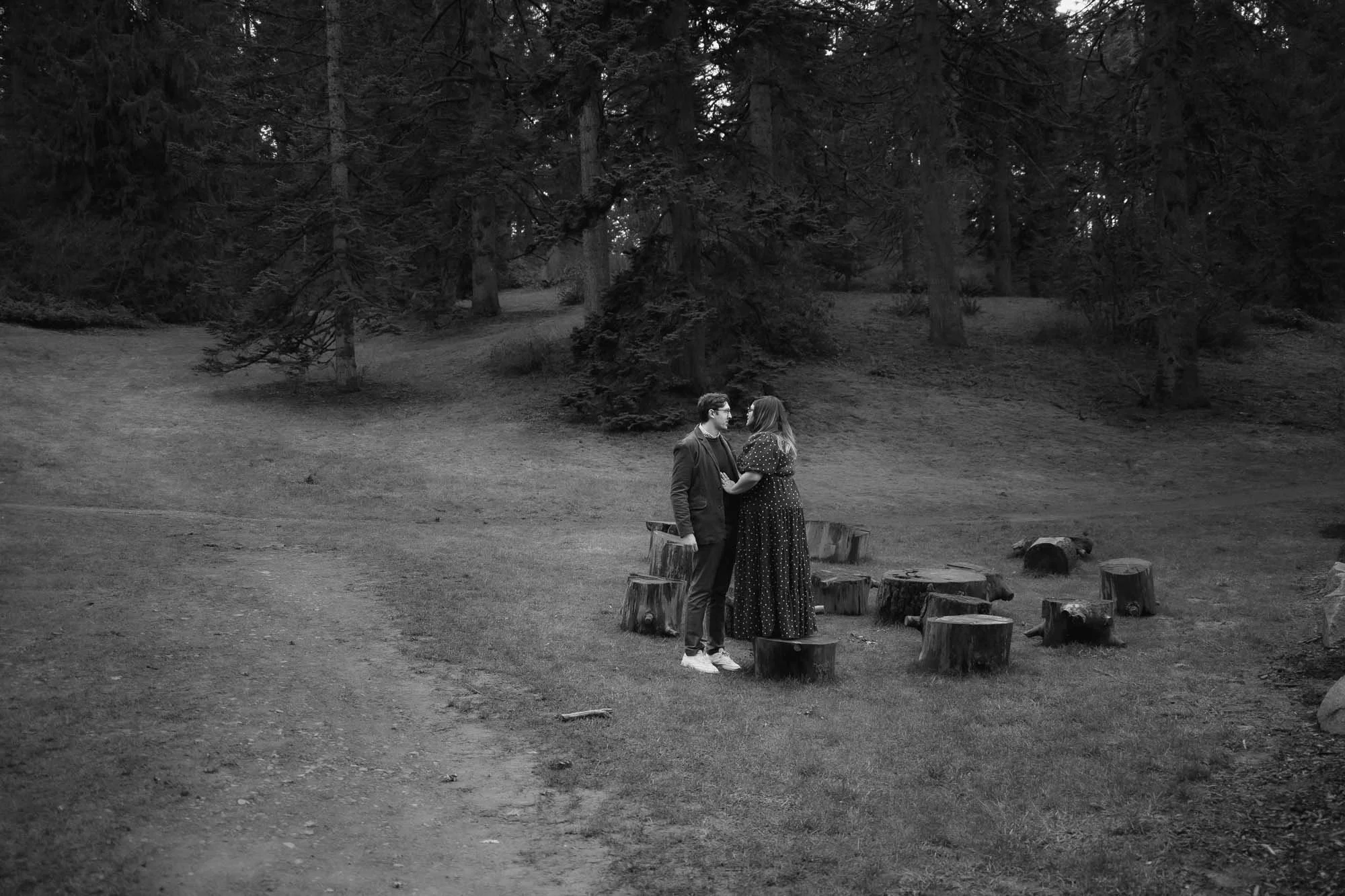 Black and white engagement photography of a couple in an open field at a Portland nature park