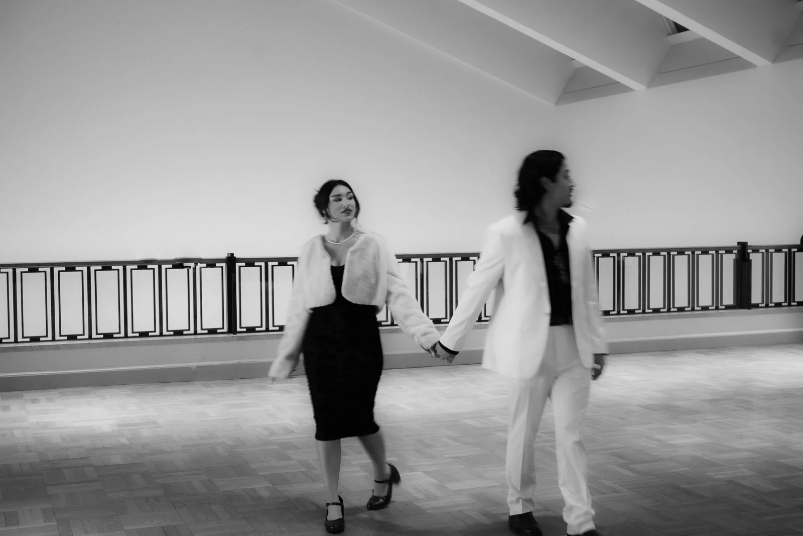  Wide angle shot of a couple waking through a large open room 