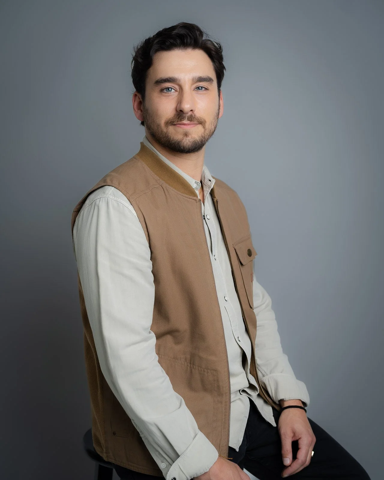 A young man with dark hair posing for a headshot