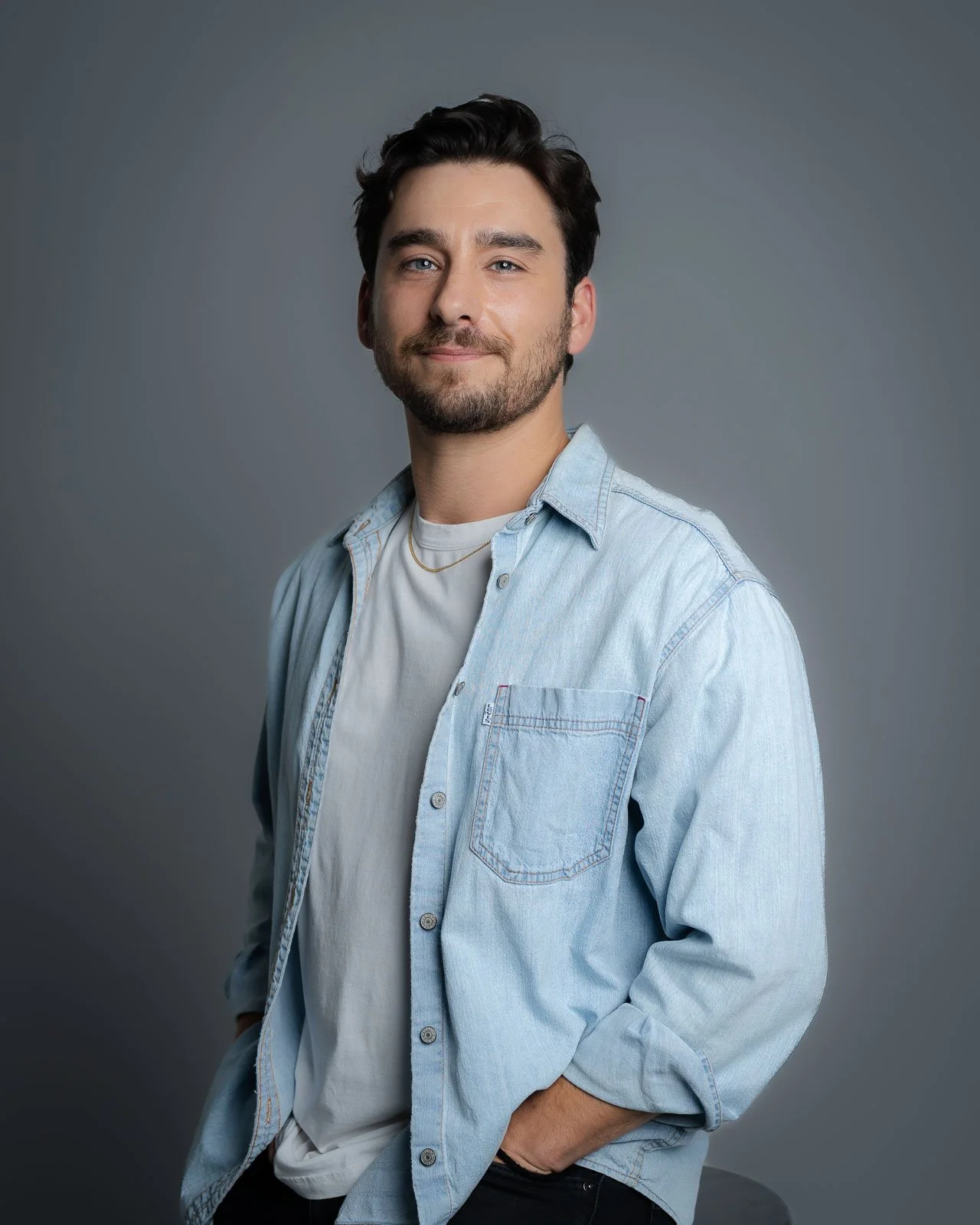 headshot of a man in a blue button up shirt