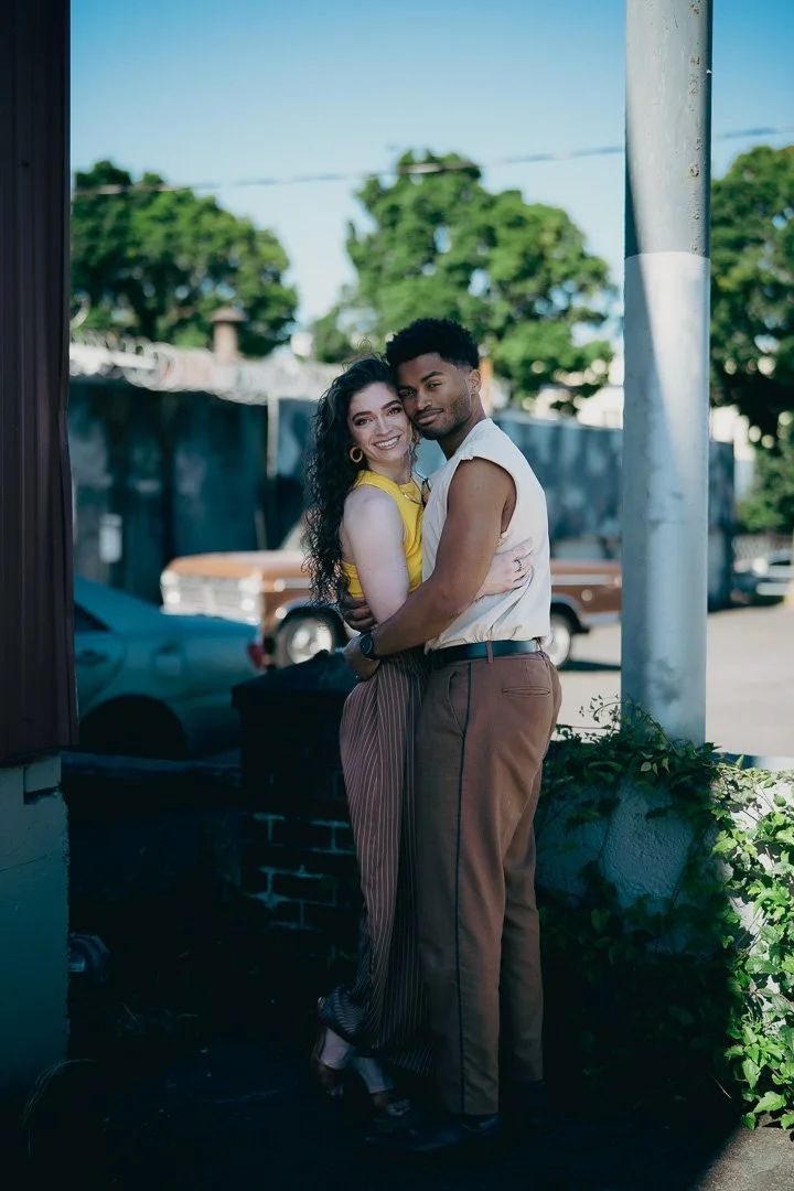 Attractive engaged couple hold each other and smile