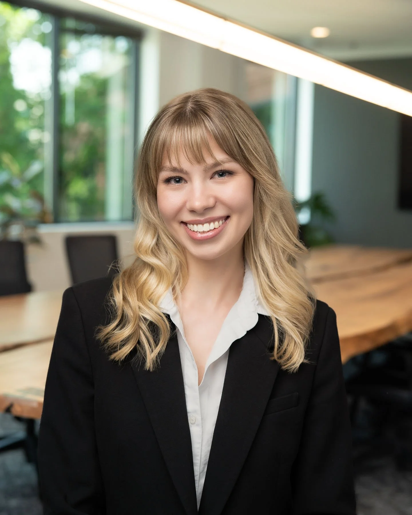  Young female lawyer in a suit smiling 