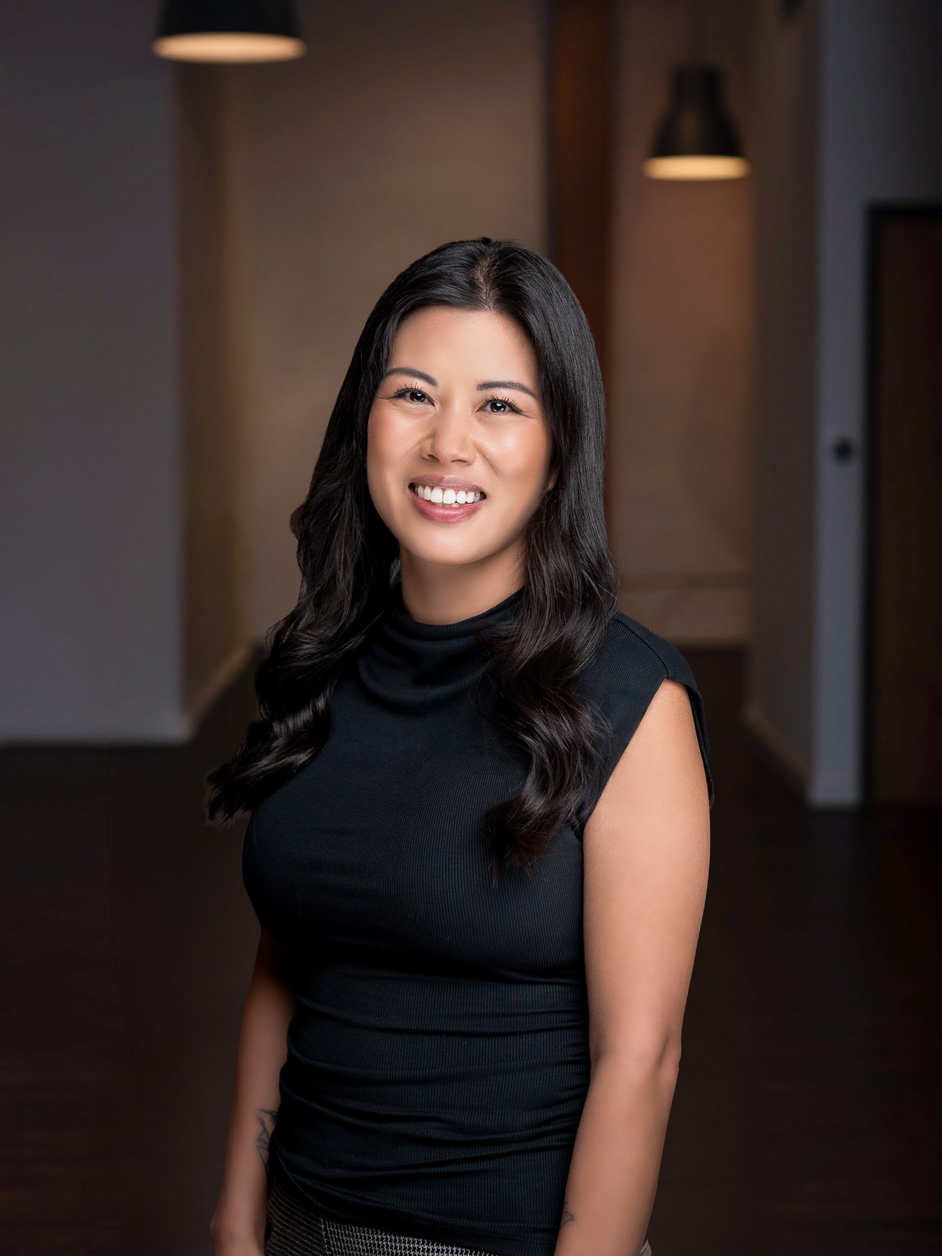  Young smiling realtor in a black turtleneck  