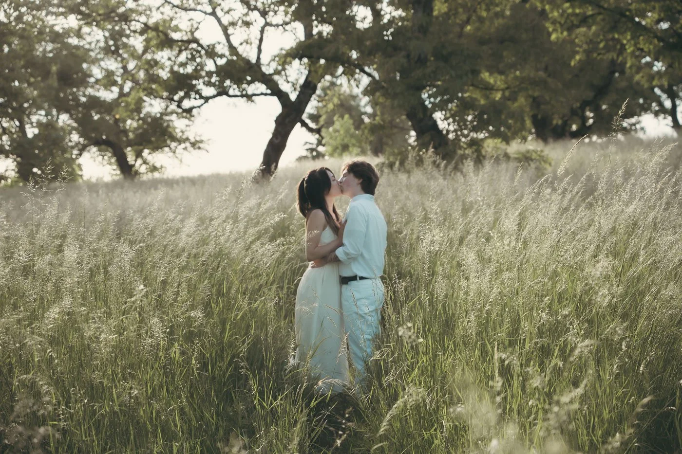 Engaged couple in a field of tall grass at Powell Butte