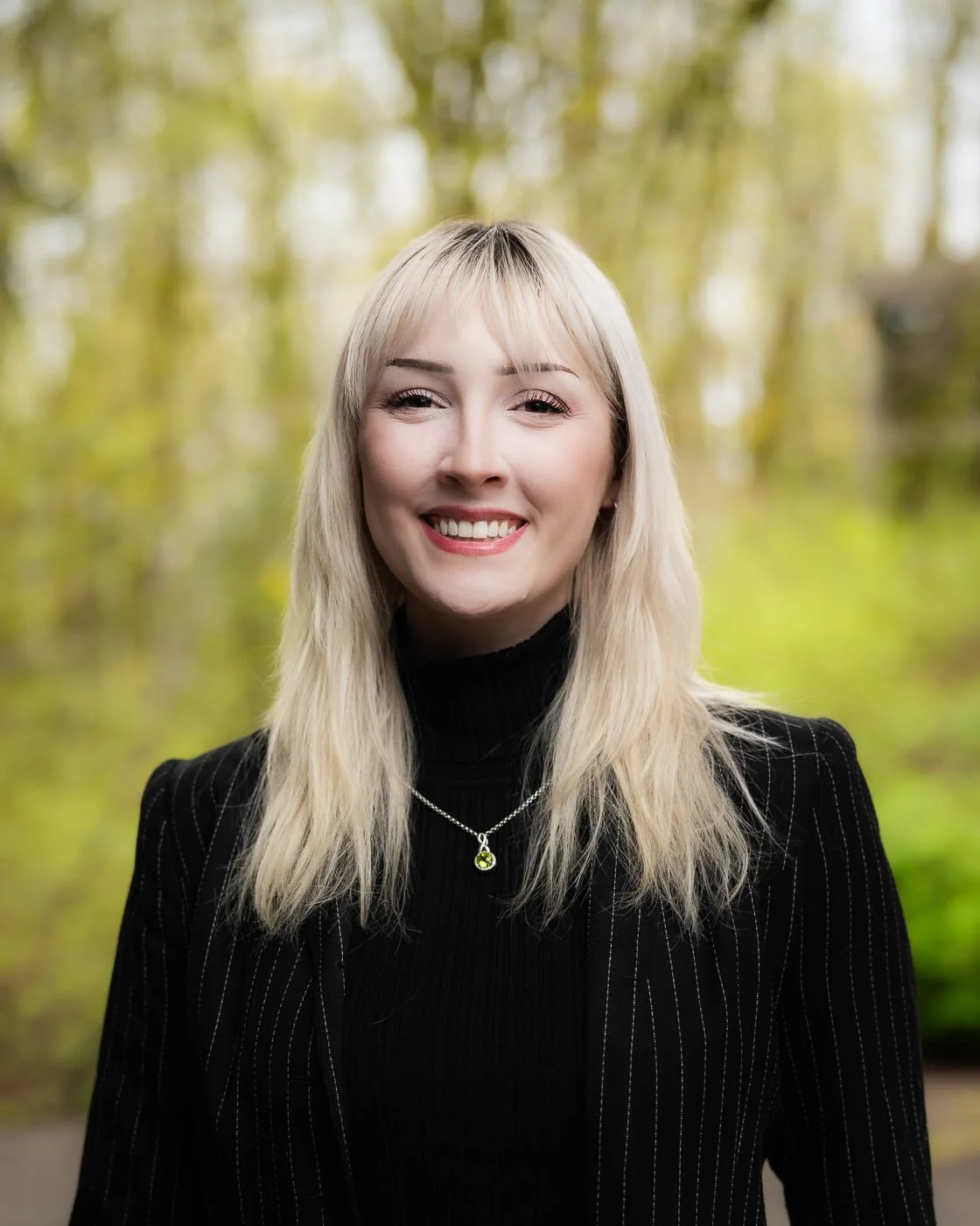 Outdoor modeling headshot with a bright green background