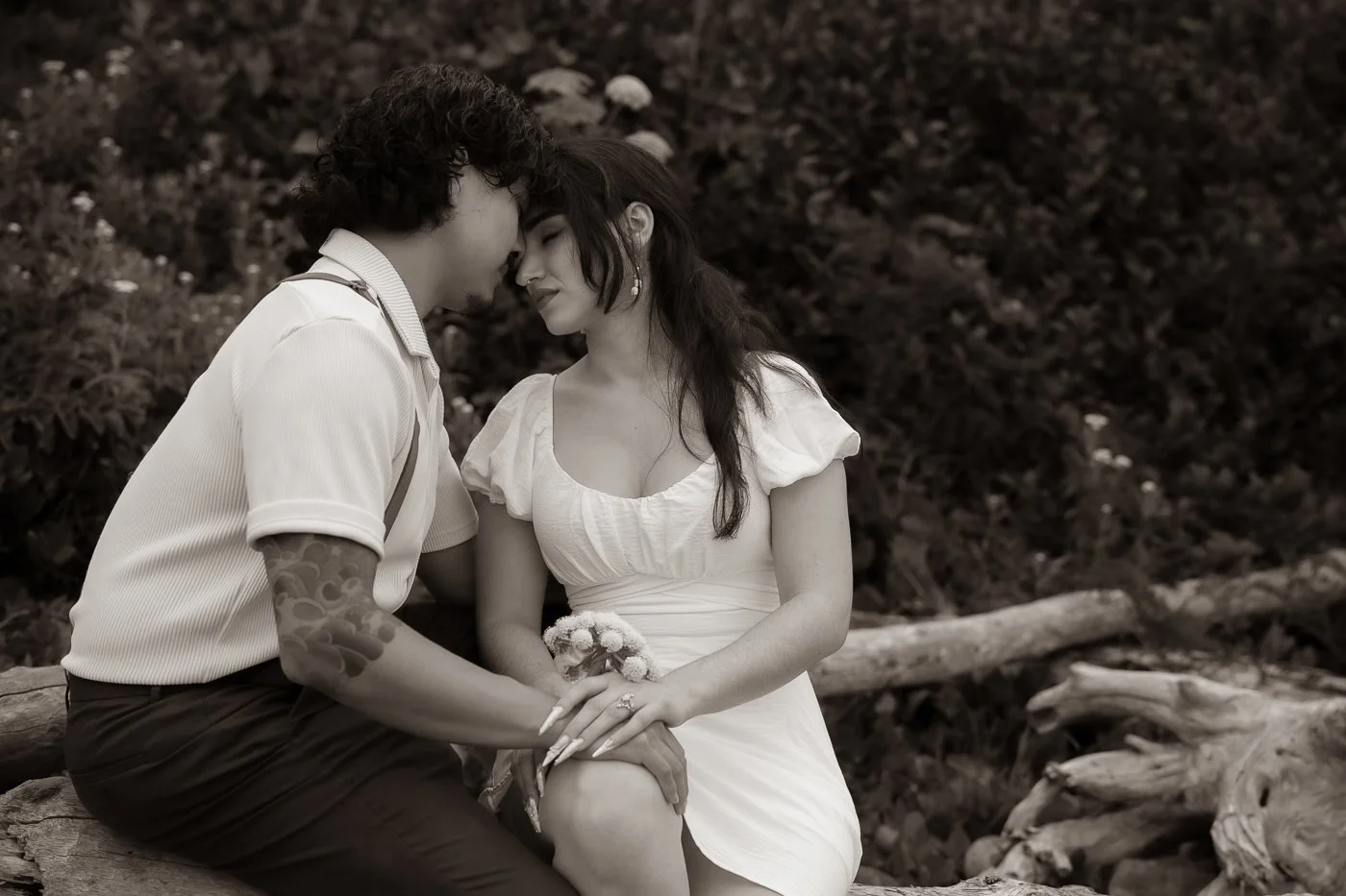 Couple in matching white getting engaged at Ecola State Park