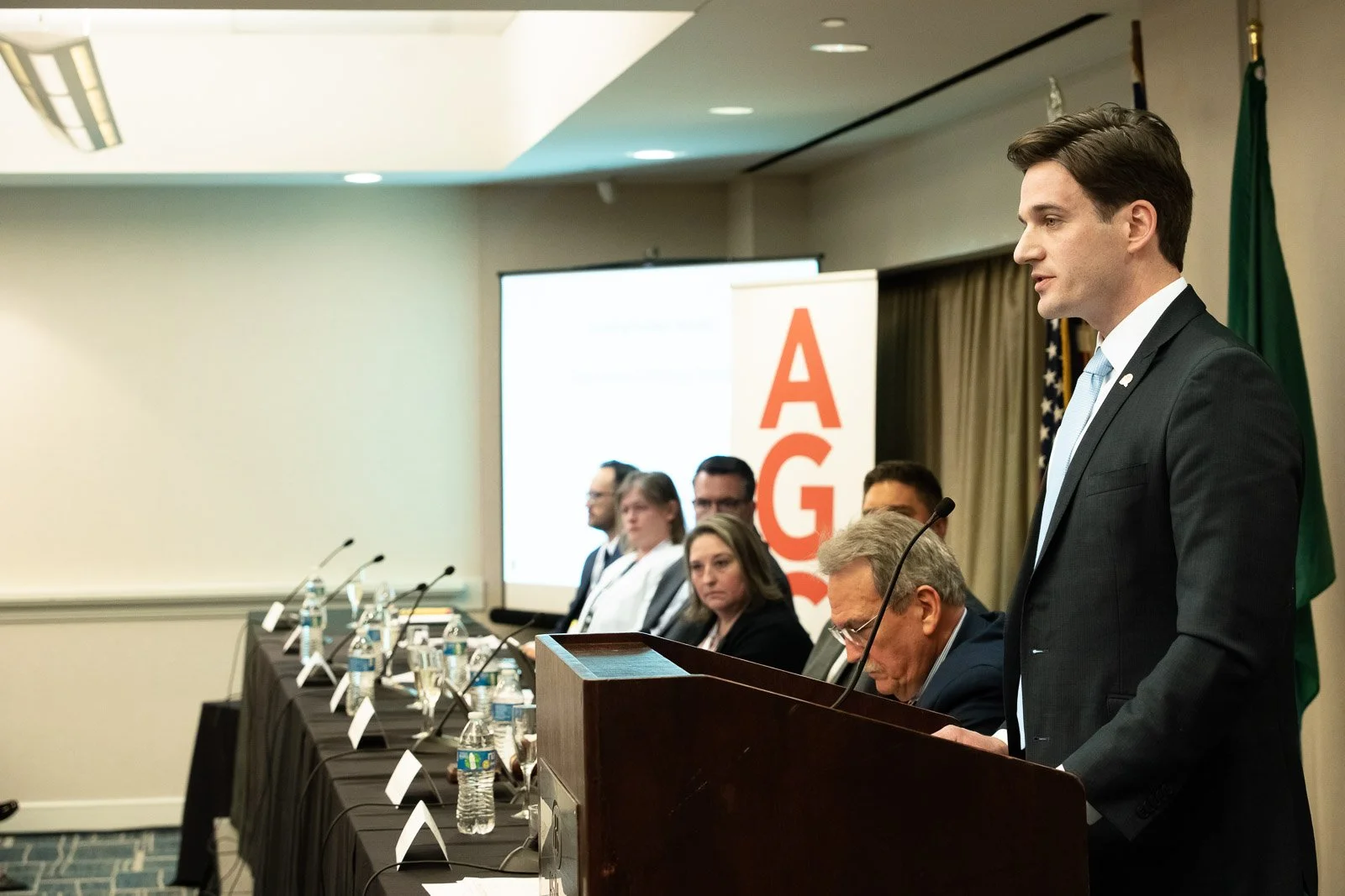 Event photography of the new president of AGC addressing the audience at a conference