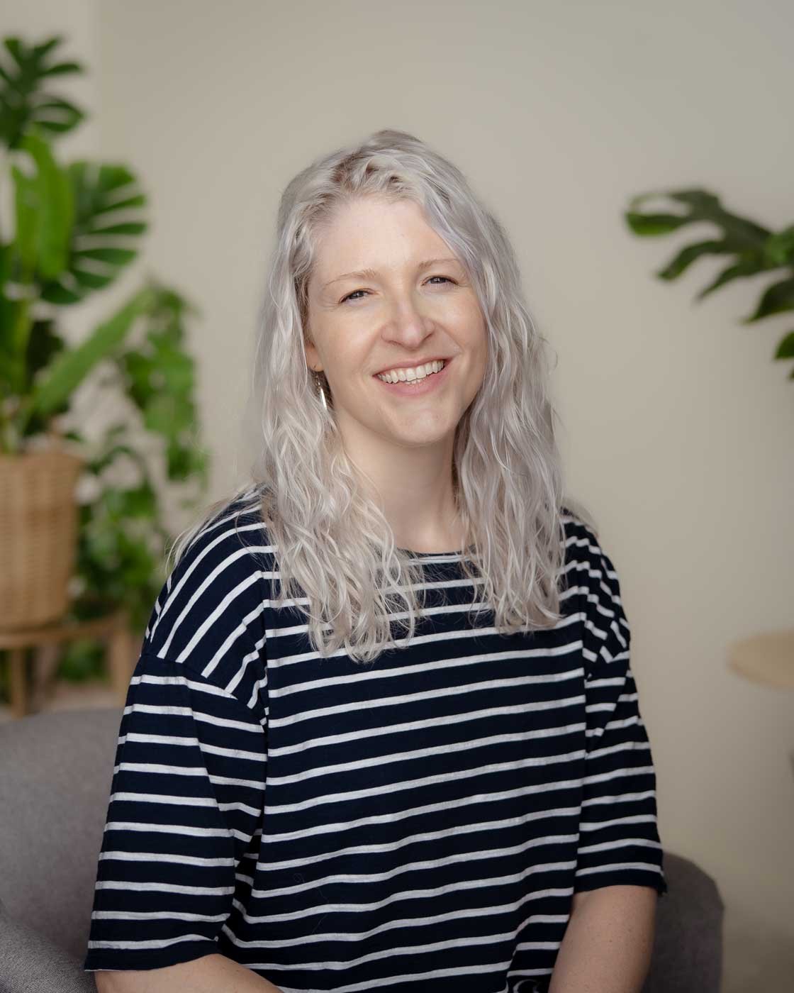 Therapist headshot in a room with plants