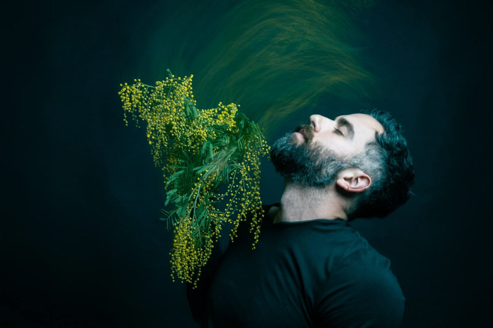 Mexican Actor, Jose Minor, holding a bouquet of yellow flowers