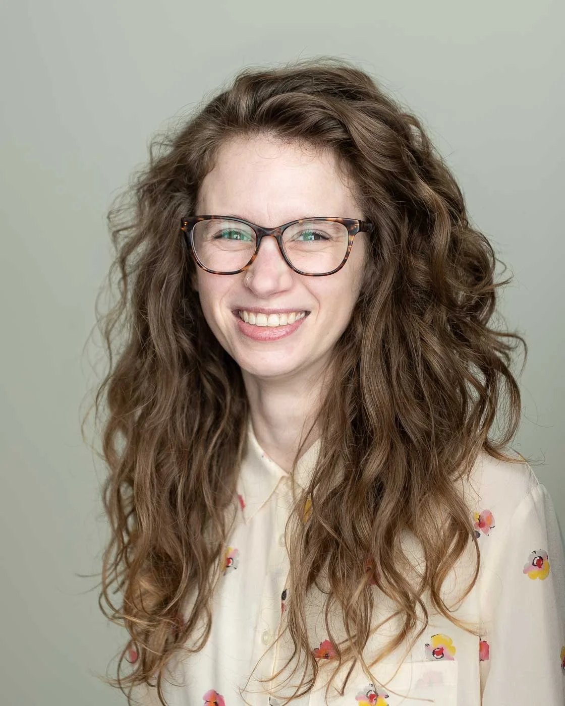 Creative headshot of a woman with wild curly hair