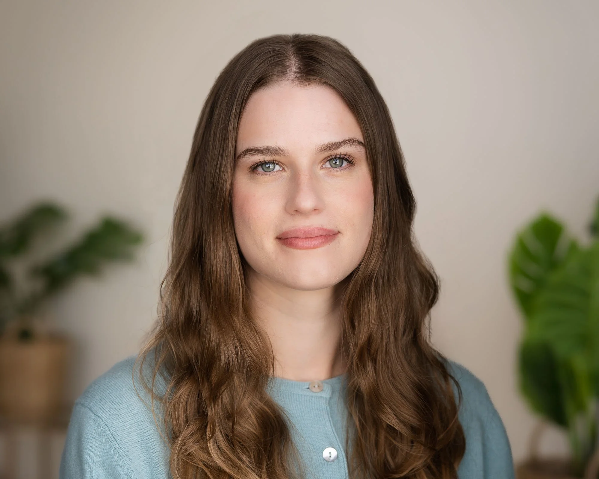 Business headshot with plants in the background
