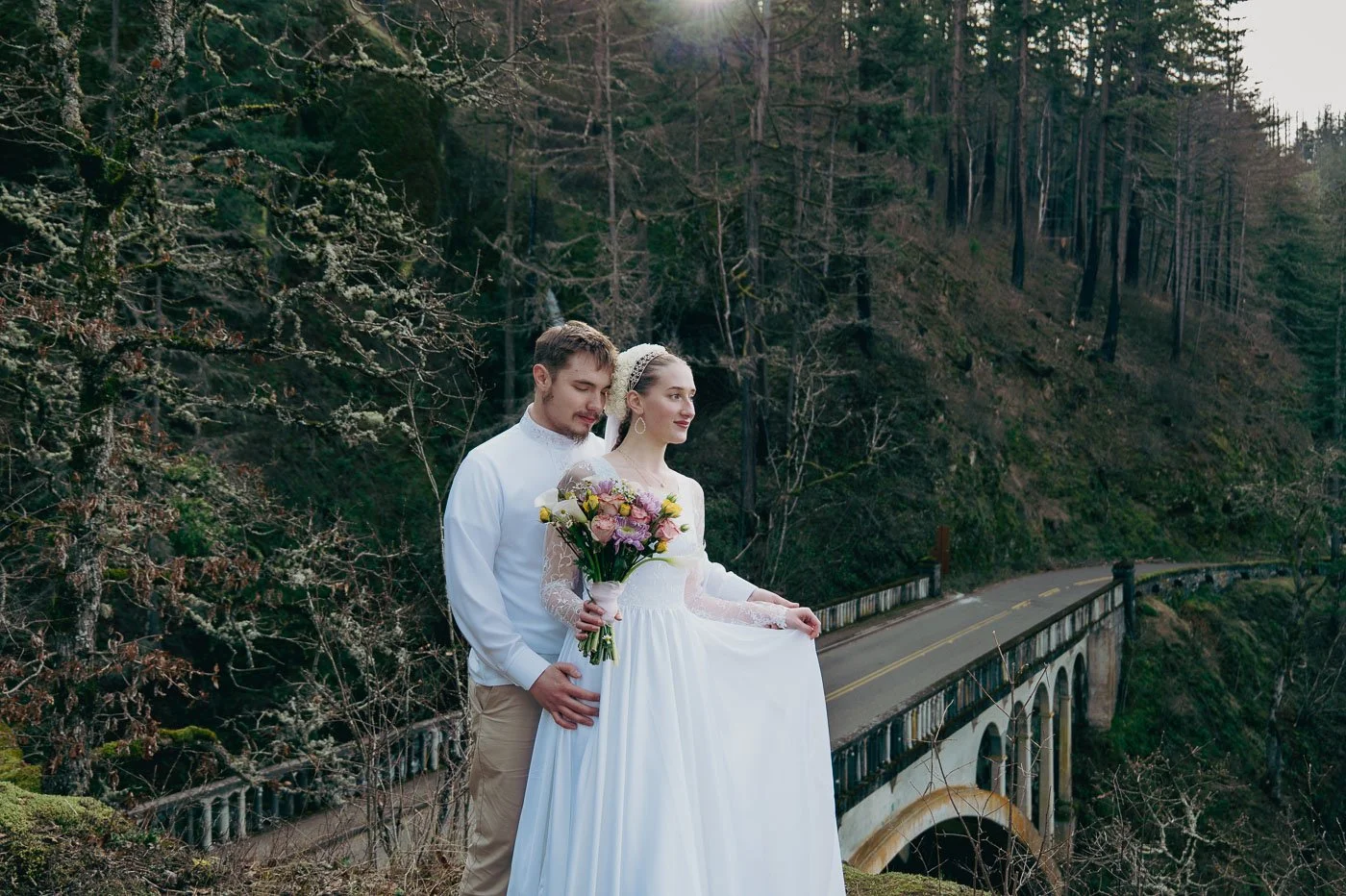 Bride and groom above a bridge by Multnomah Falls