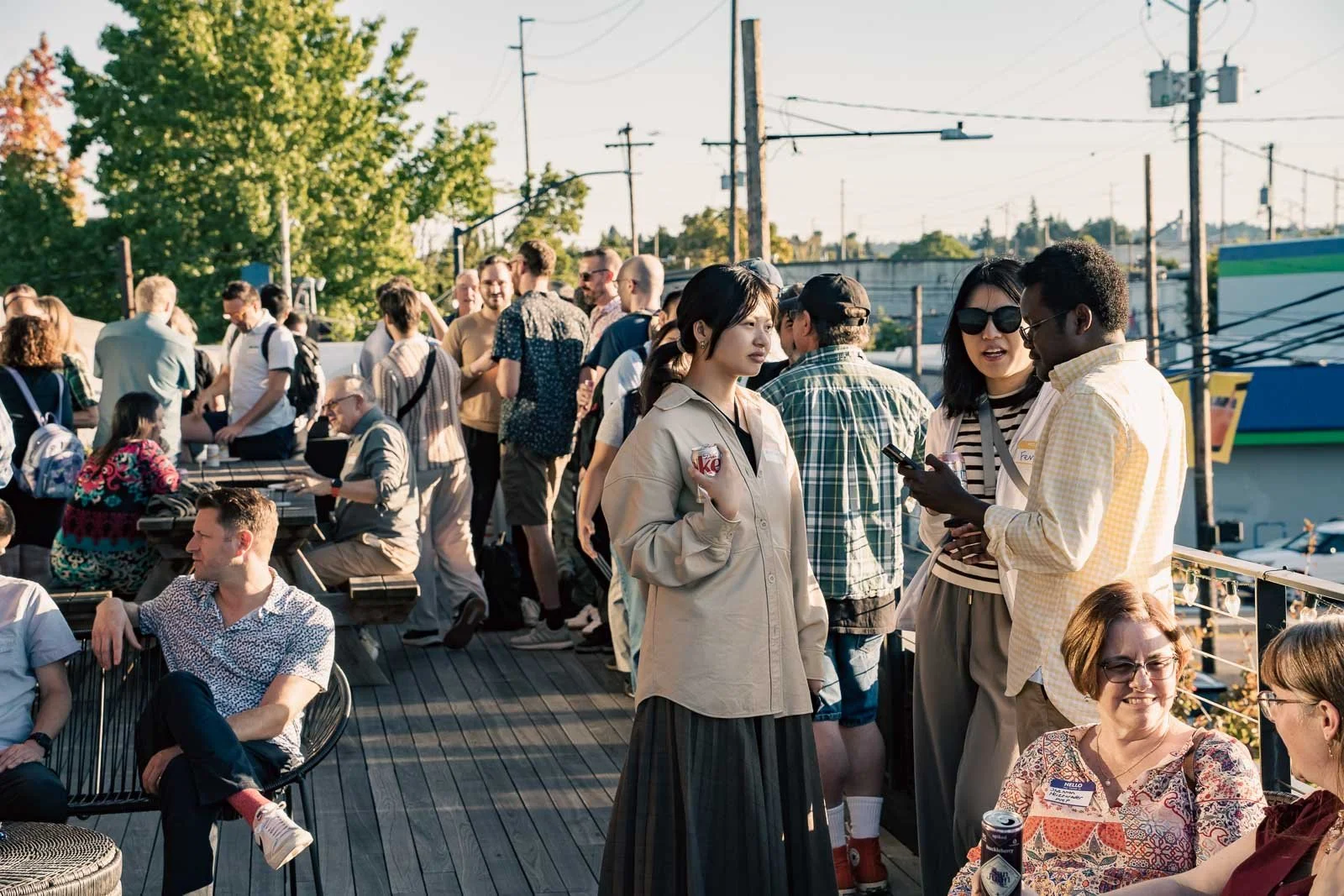 People in groups talking on the patio of Kiln
