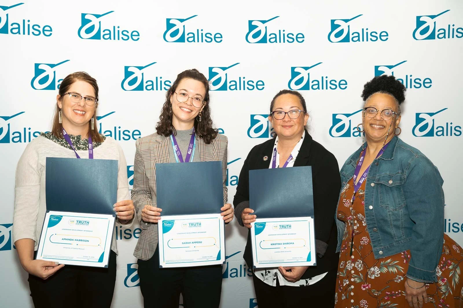 Four award winners showing their awards at the Alise Annual conference in Portland