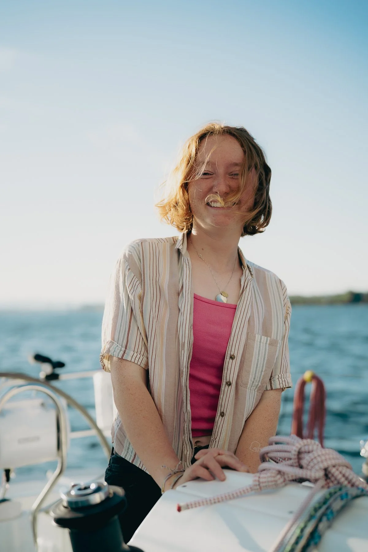 Young cheery girl on a sailboat 