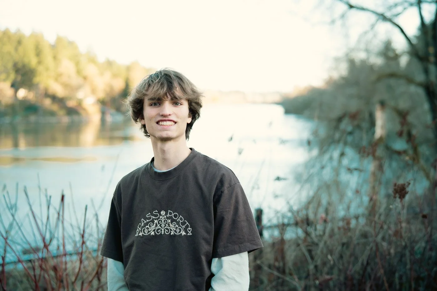 Smiling student in front of the West Lynn river 