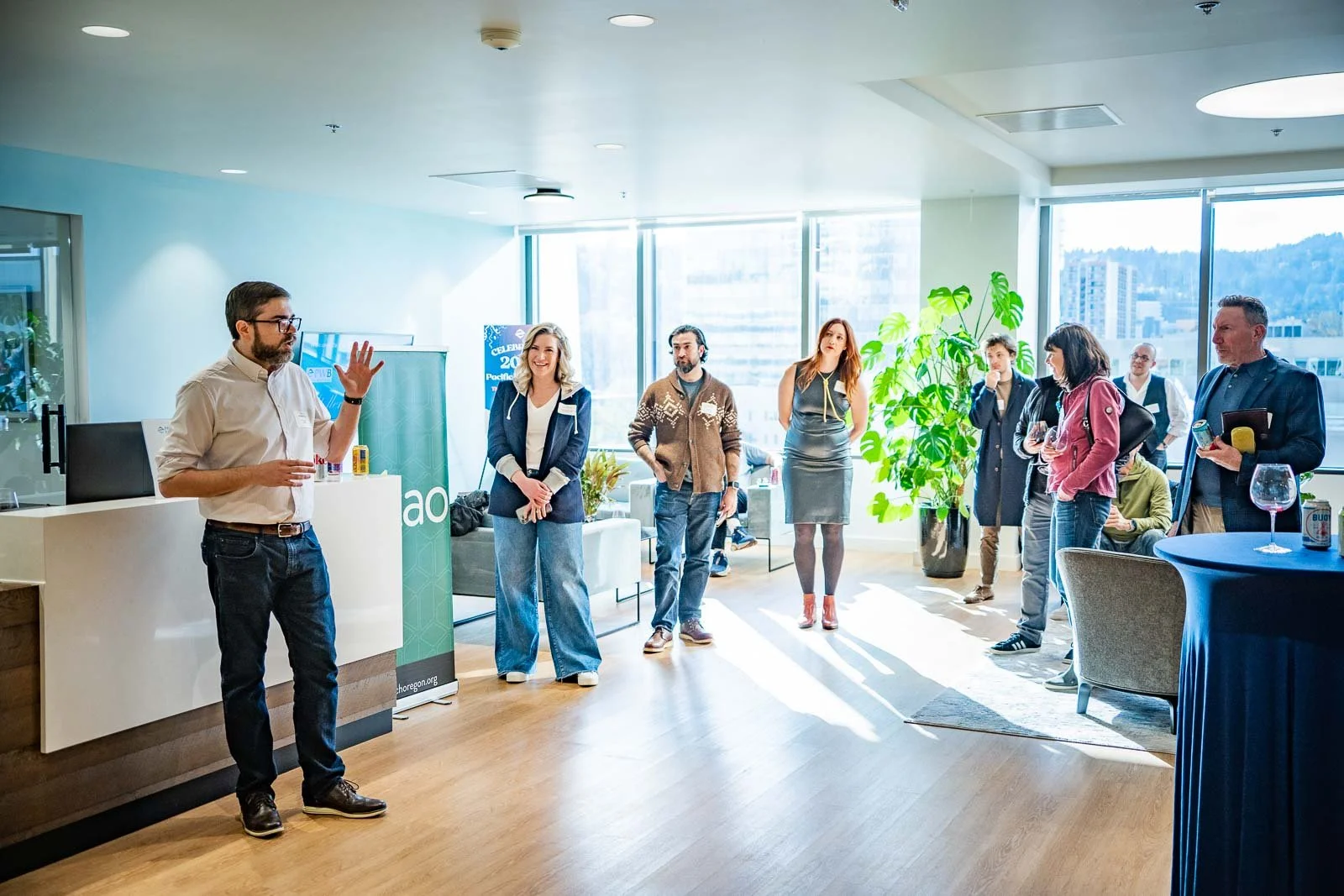 Presenters in a large sunny room in the Pacific West Bank building