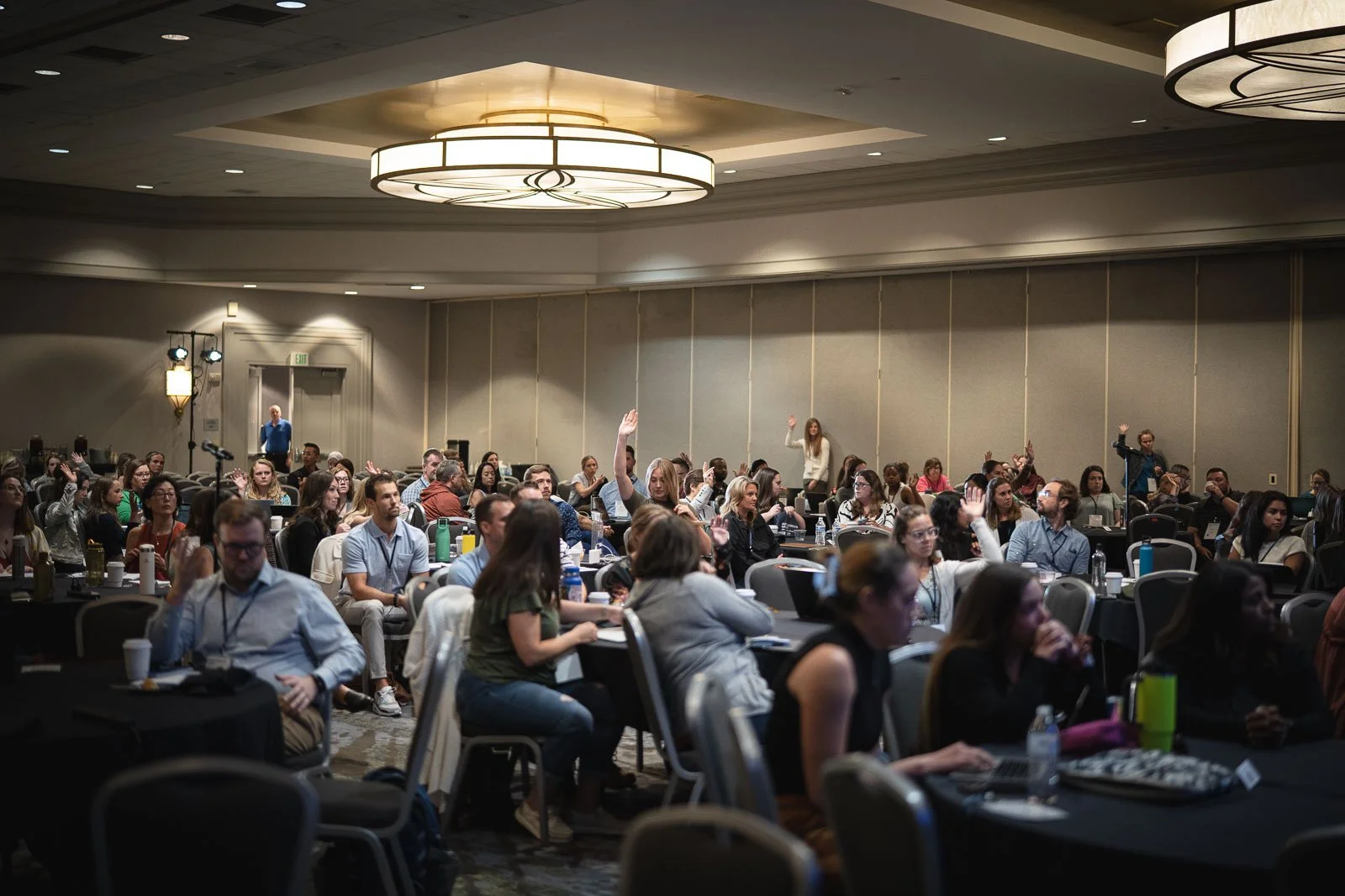 People in the crowd raising their hands during a Portland conference
