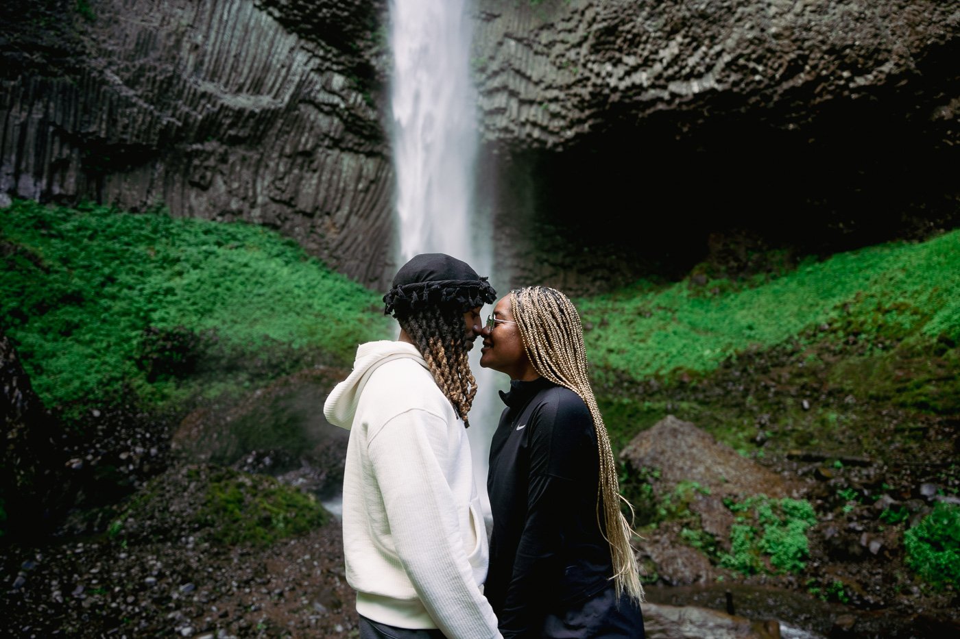A couple kissing in front of Latourell Falls waterfall