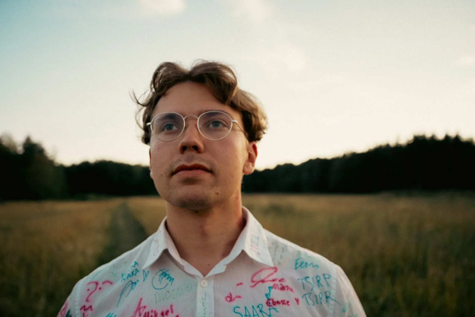 An artist at a music festival standing in an open meadow