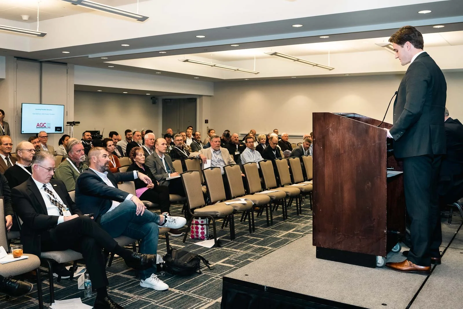A conference room with a speaker at the podium