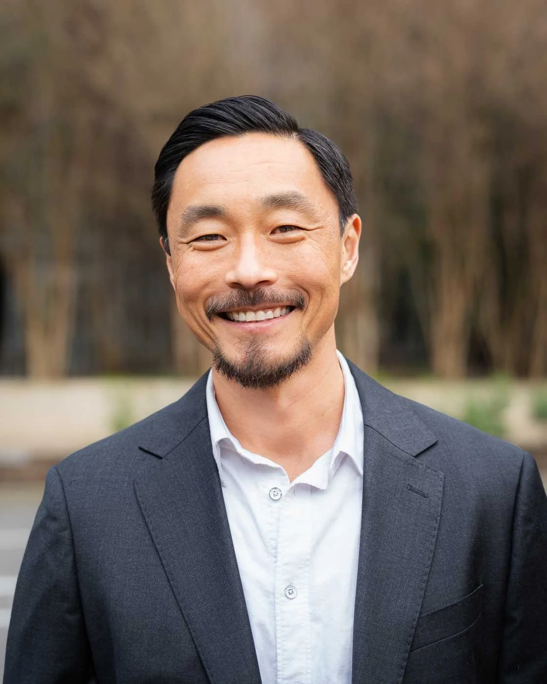 Smiling man poses for his headshot in downtown Portland