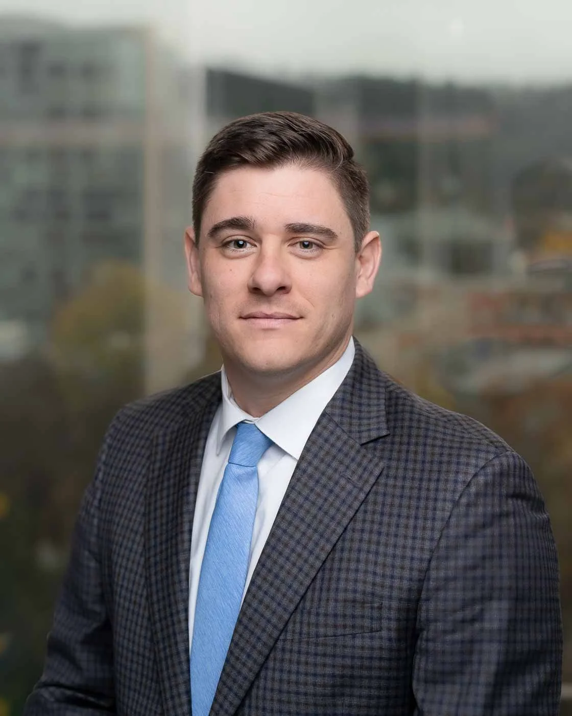 Corporate employee headshot with the Portland skyline in the background