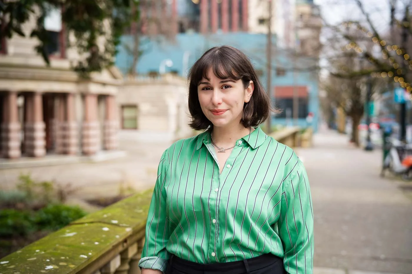 A colorful outdoor headshot of a female lawyer in downtown Portland