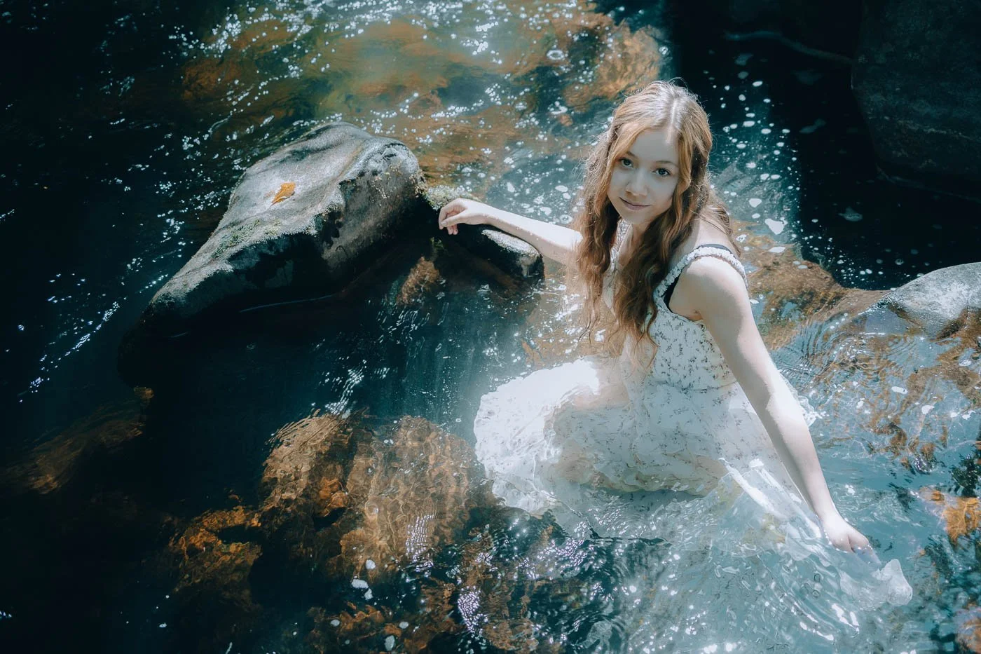 Dreamy high school portrait shoot in a river