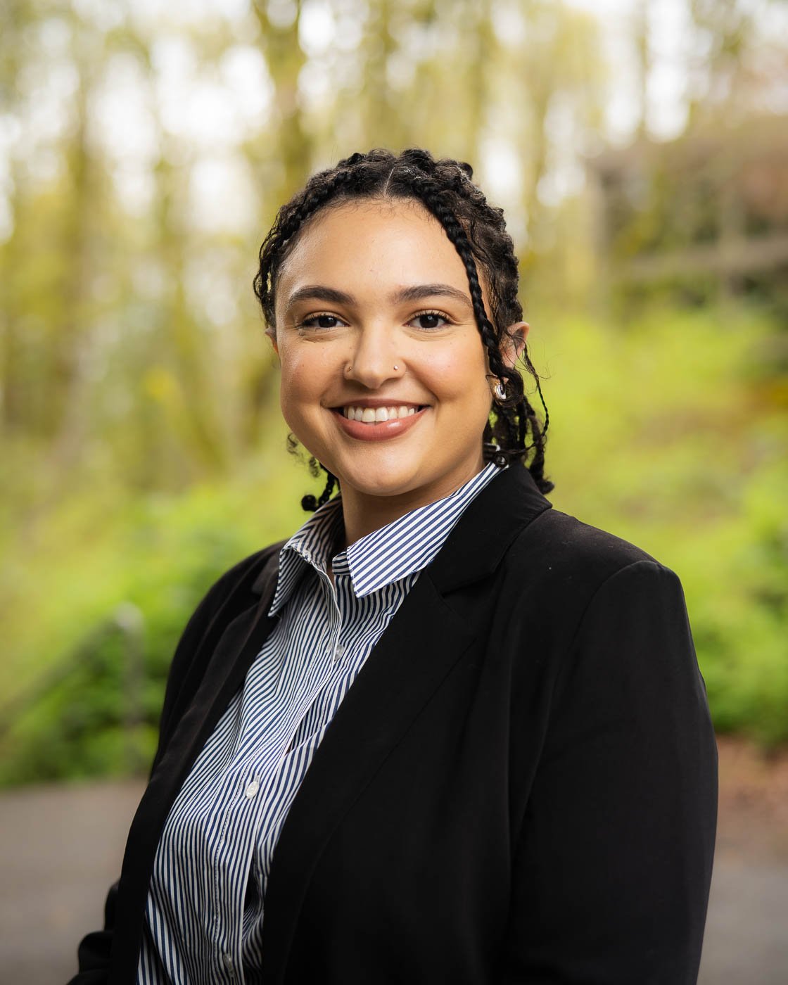 Outdoor corporate headshot of a young smiling woman