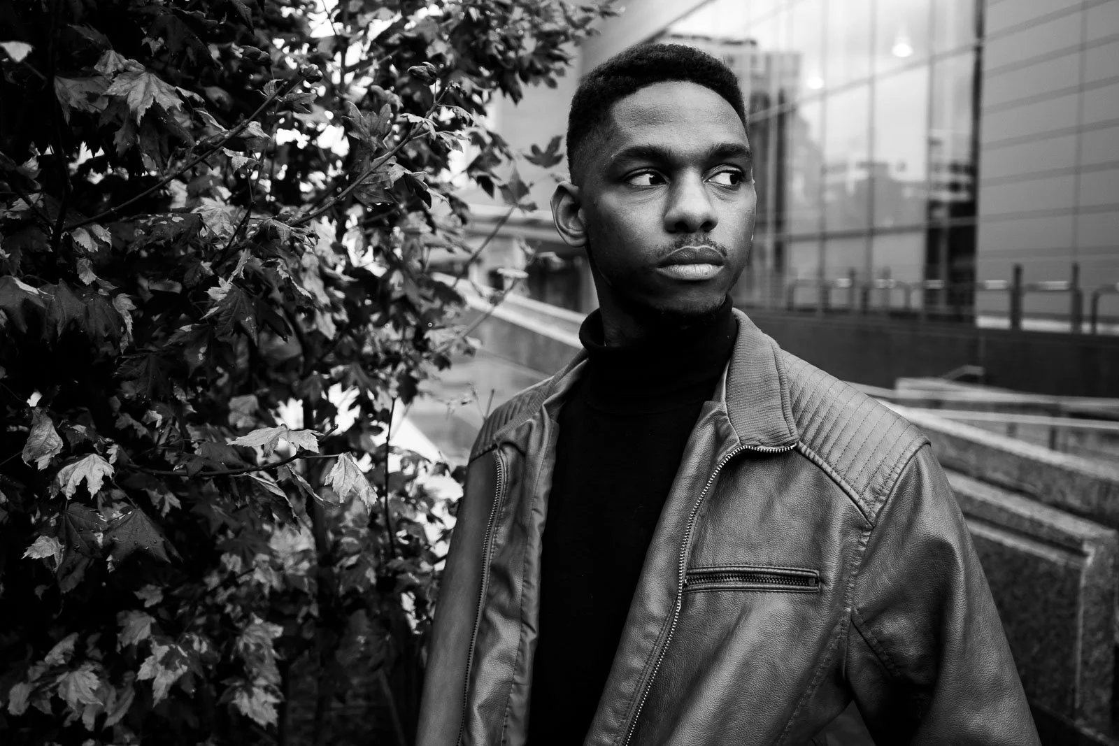 A black man in a leather jacket in downtown portland