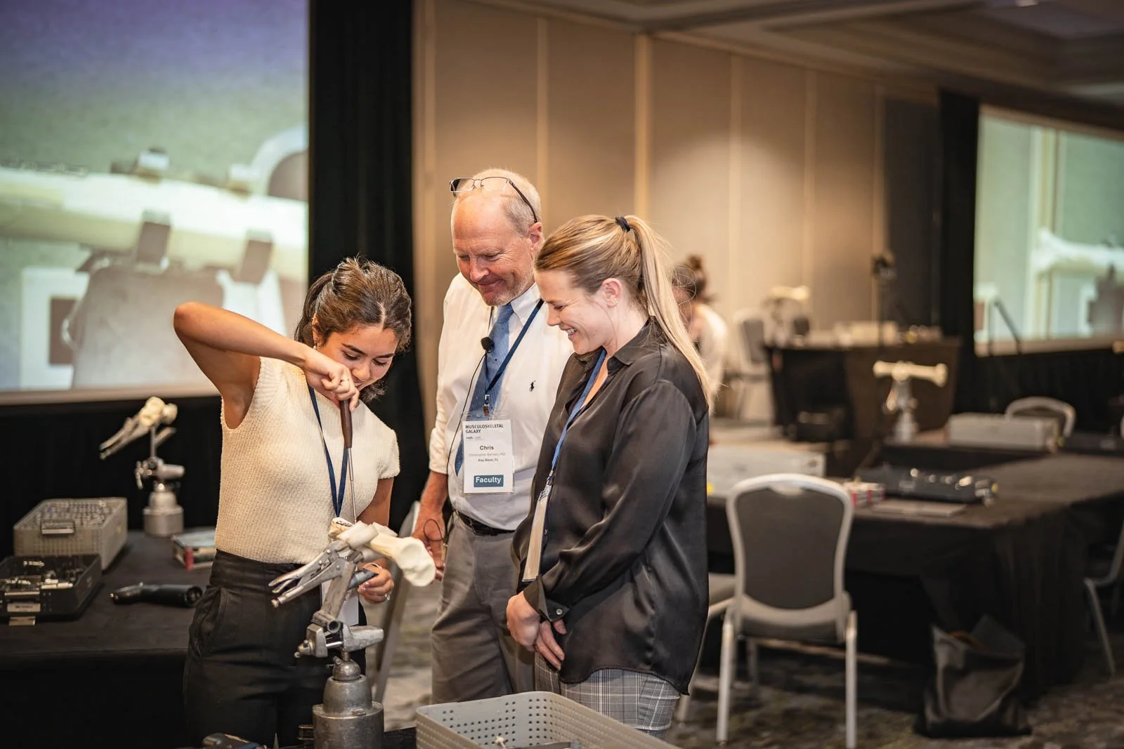 Two young women attending a medical workshop working with bones