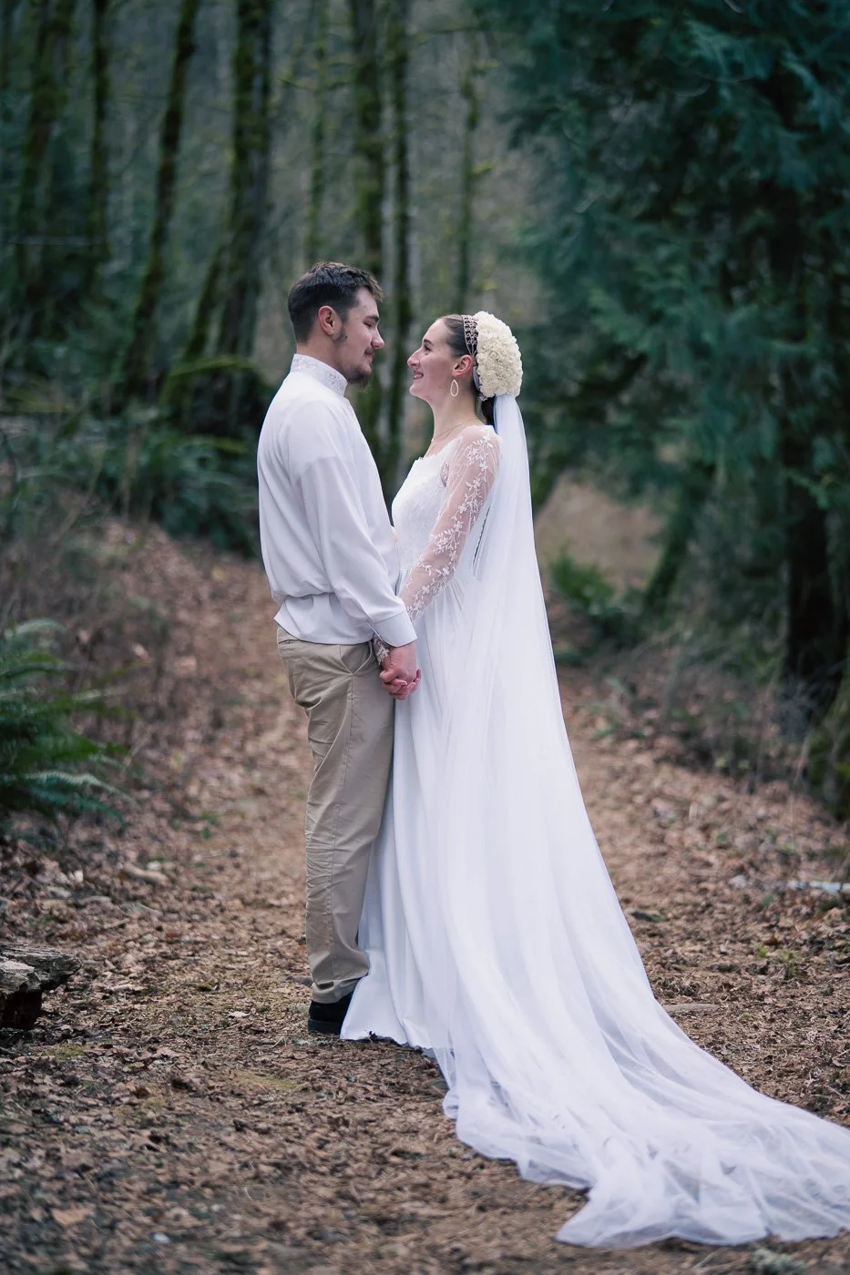 Bride and groom on a path in the forest