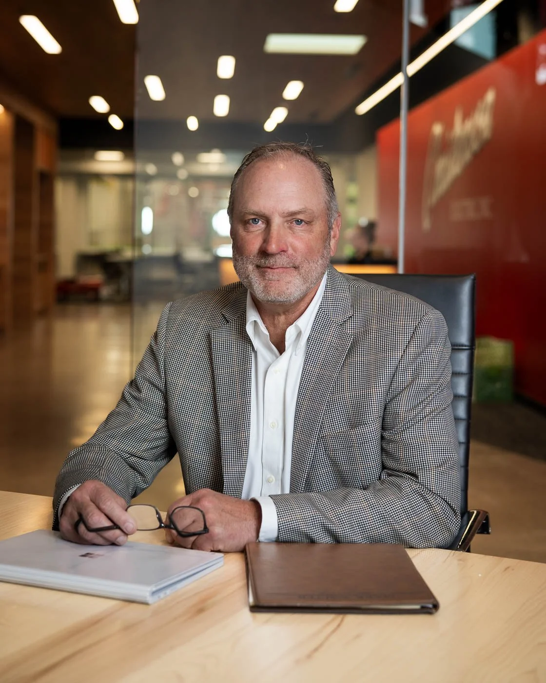 Company president at a desk with his computer