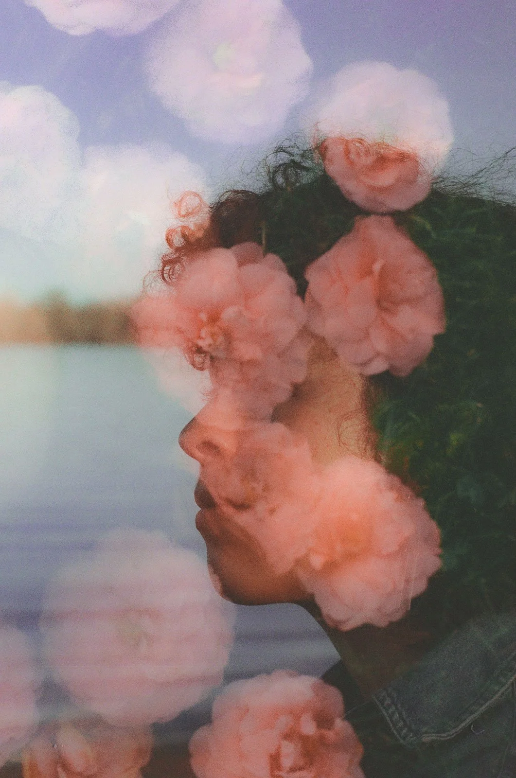 Creative portrait of a Portland author and artist with flowers covering her face