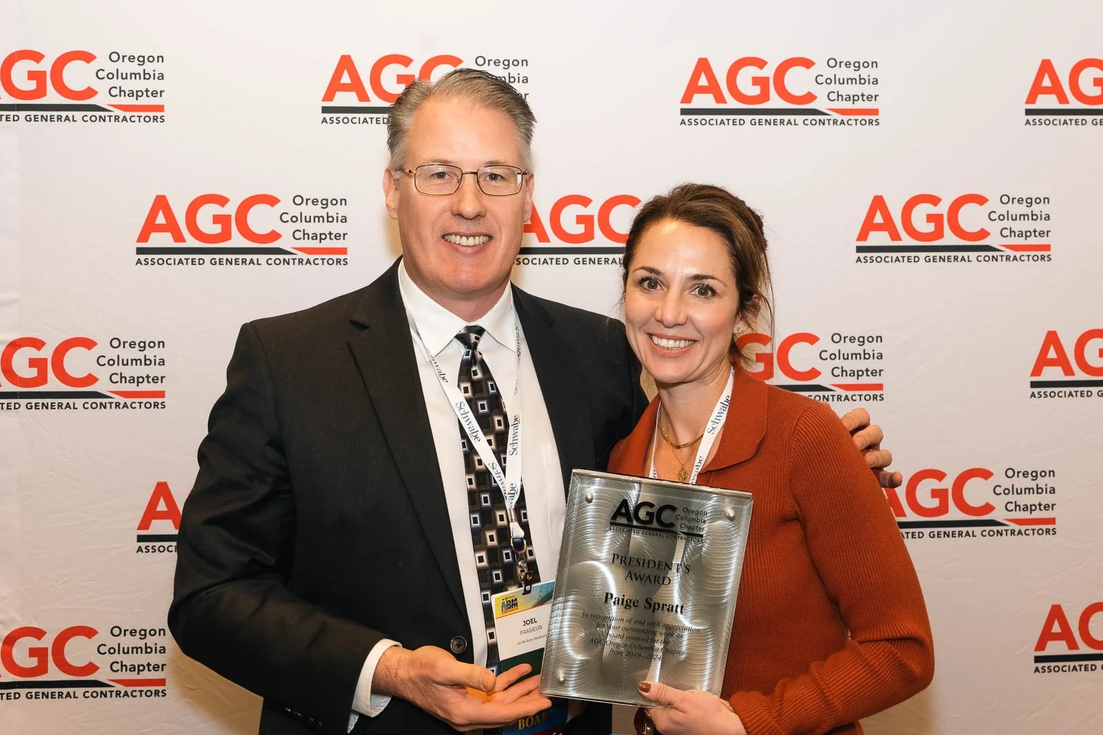 Award winner, Paide Spratt, in front of a step and repeat at the AGC conference