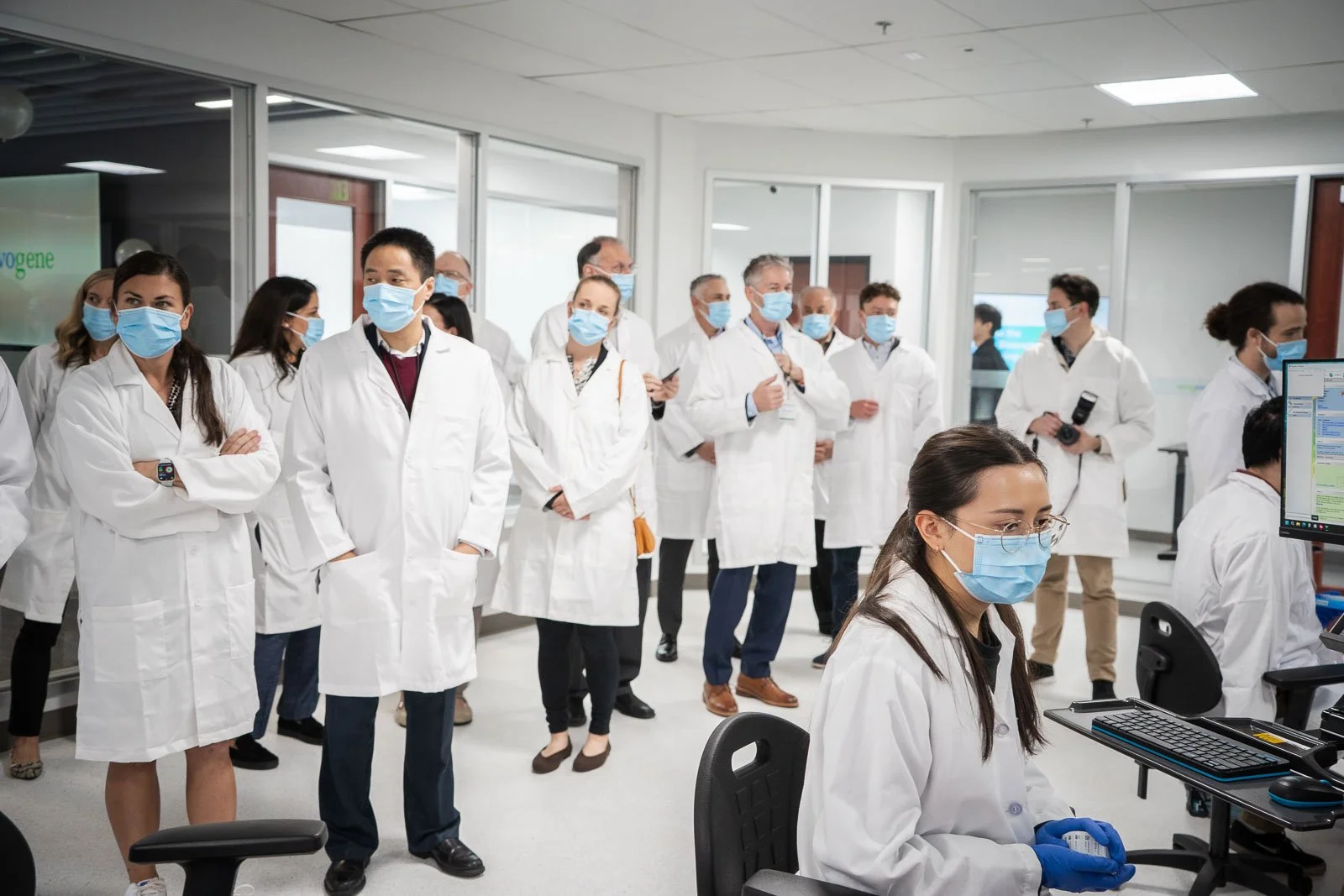 A group of people in white lab coats inside the Novogene lab
