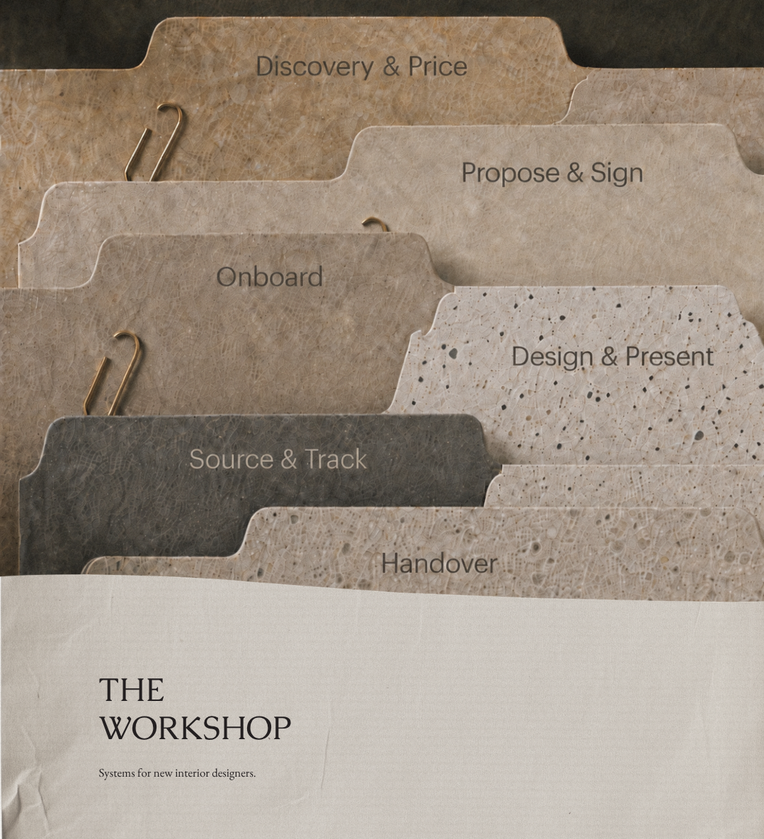 Image showing five physical folders labeled 'Discovery & Price,' 'Propose & Sign,' 'Onboard,' 'Design & Present,' 'Source & Track,' and 'Handover,' with a section at the bottom titled 'The Workshop' and the subtitle 'Systems for new interior designers.'