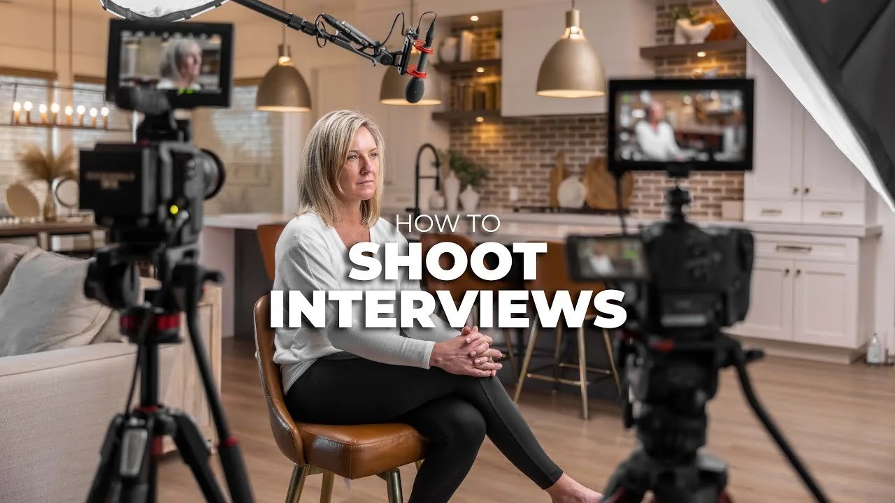 A woman participating in a video interview setup in a modern kitchen with cameras, a microphone, and lighting. The text overlay reads 'How to Shoot Interviews.'