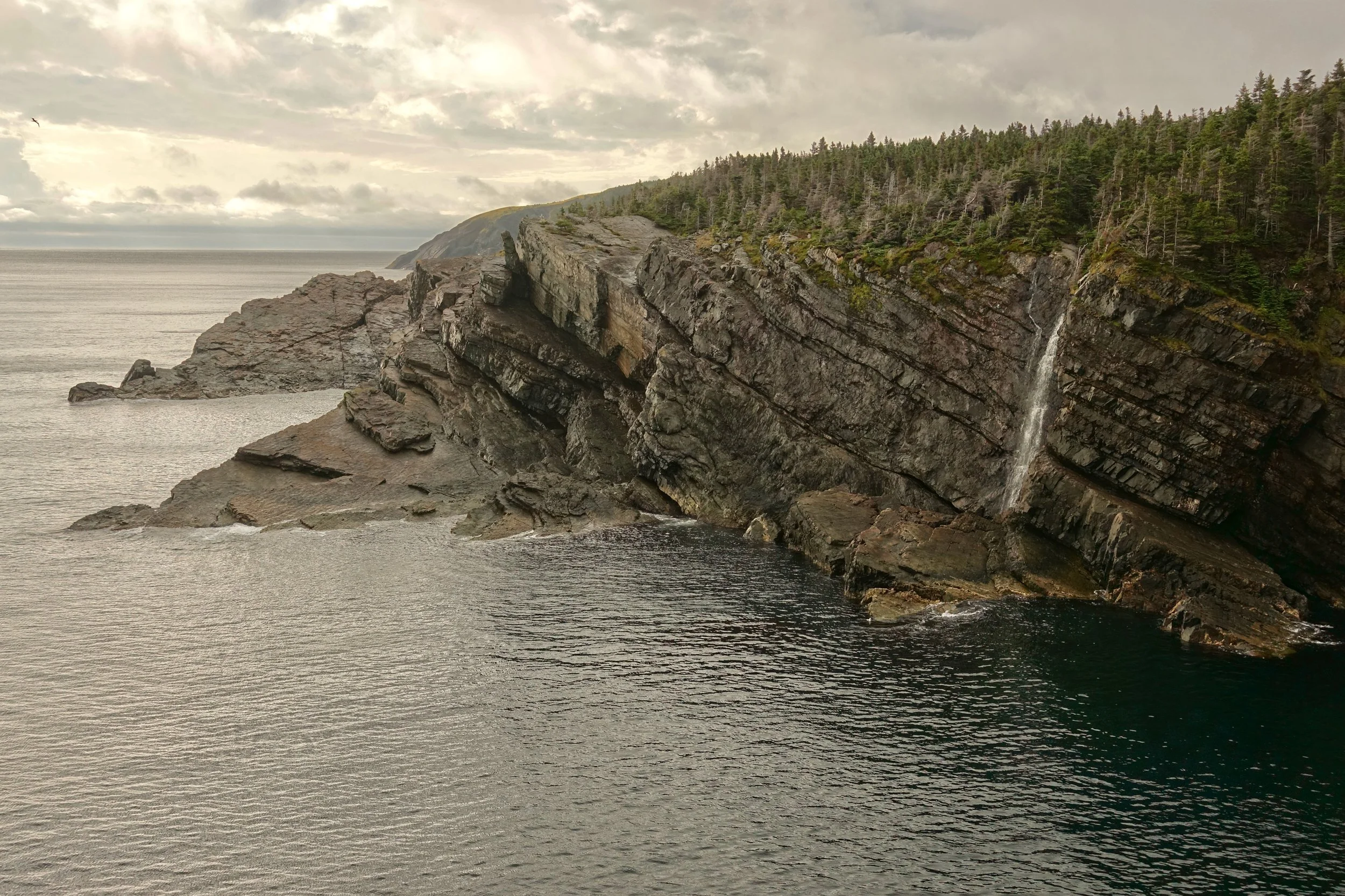 Waterfall on the coastal cliffs around Stiles Cove on the East Coast Trail in Newfoundland