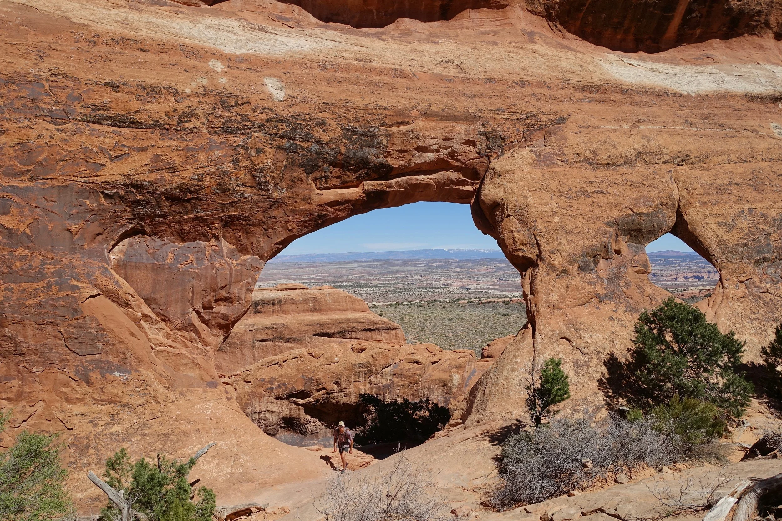 Hiker walking up through the arch