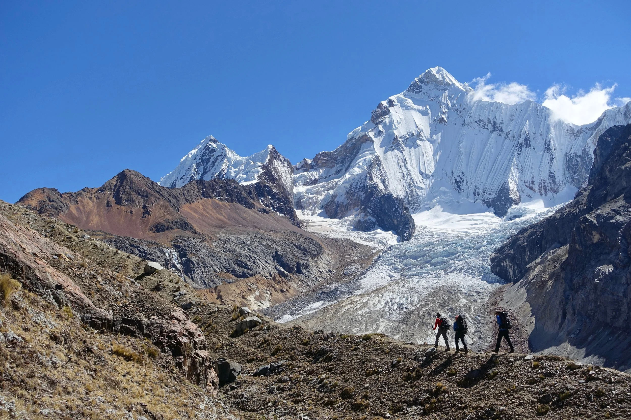 Walking along the ridge on Cordillera Huayhuash circuit hike in Peru