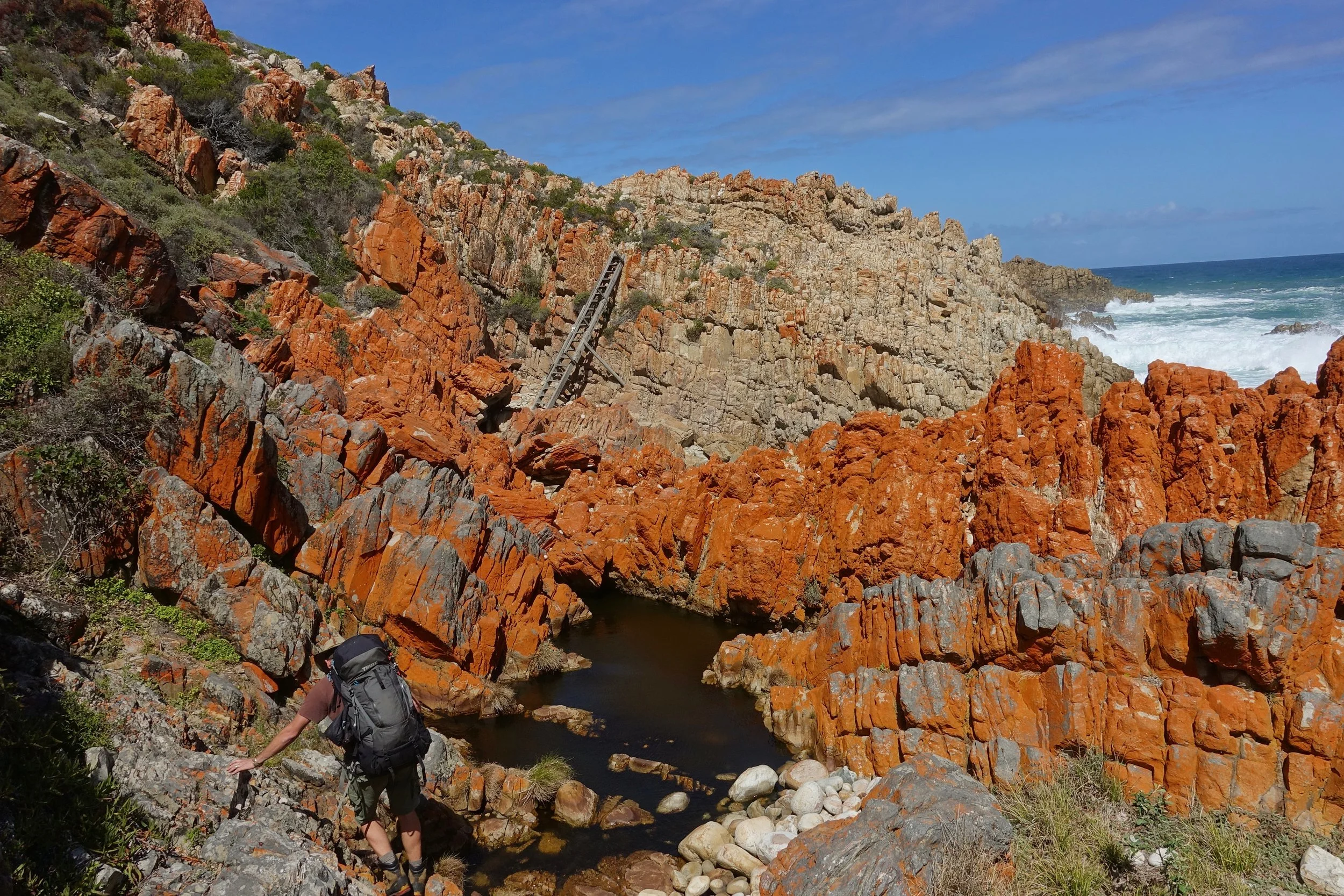 Ladders and orange rocks on the Harkerville coast hike in South Africa
