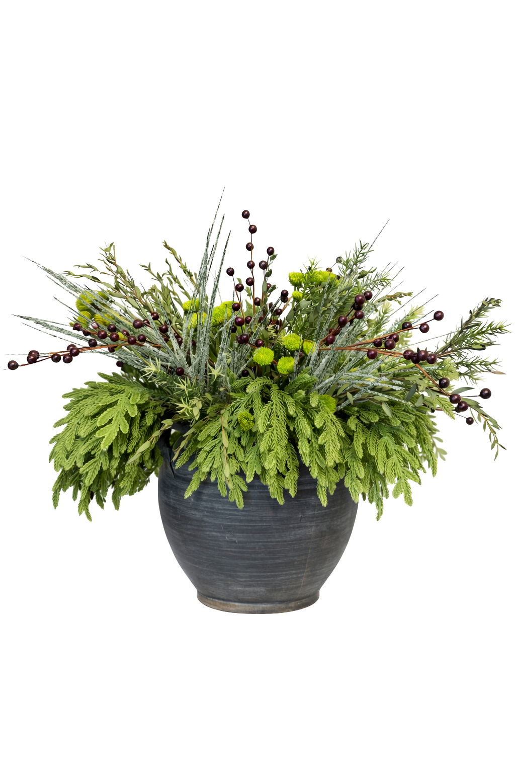A decorative floral arrangement in a black ceramic pot contains green foliage, small green flowers, and dark purple berries.
