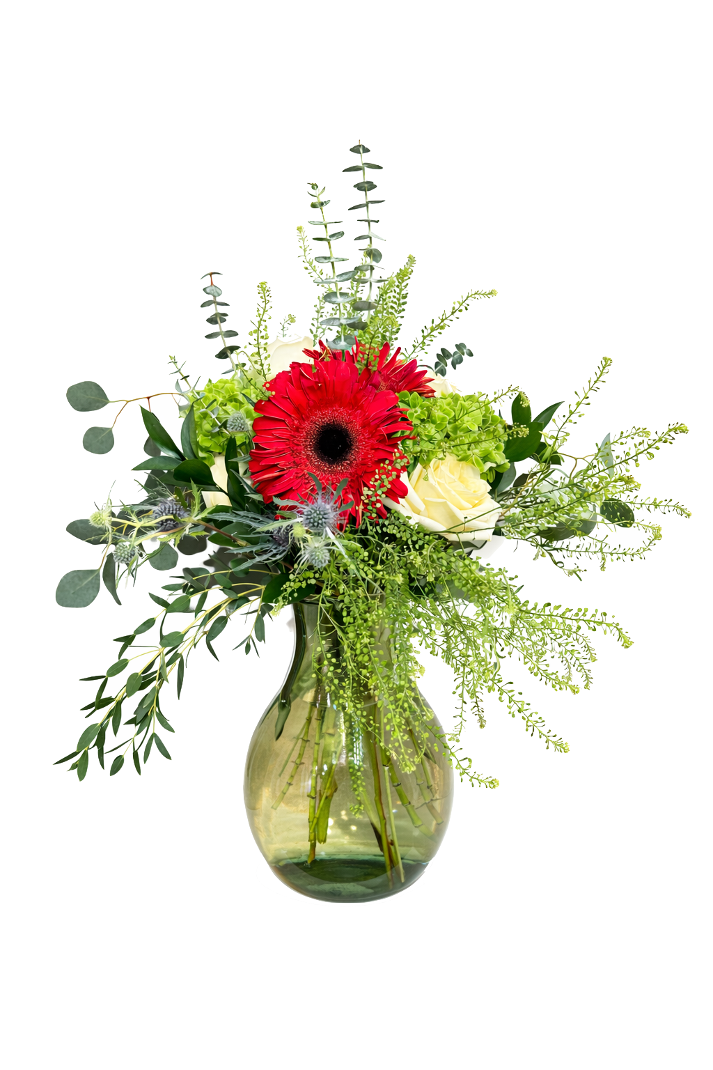 A red based bouquet of mixed flowers in a wicker vase, featuring red, cream, and yellow blooms with green leaves.