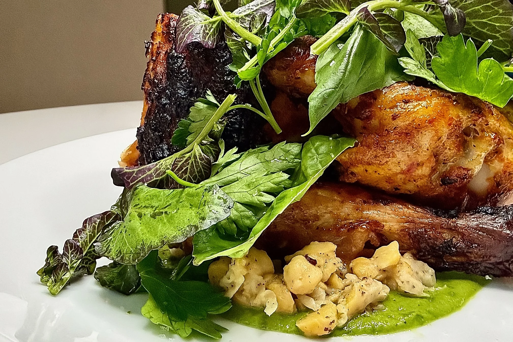 Roasted Piri Piri Chicken by Chef Cliff Crooks at Viv & Jules Hoboken, served with a warm crushed chickpea salad and fresh salsa verde.