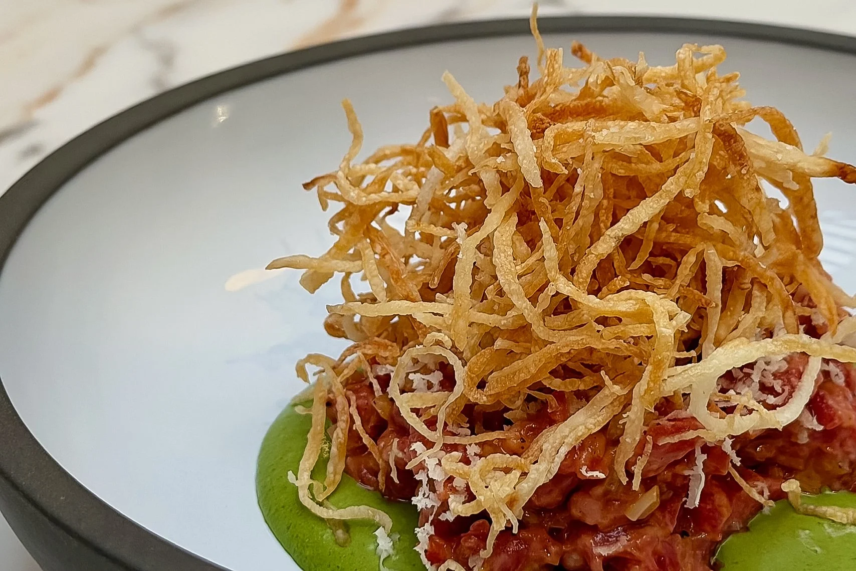 Beef Tartare with Calabrian chili and beef tallow shoestring potatoes at Viv & Jules Hoboken.